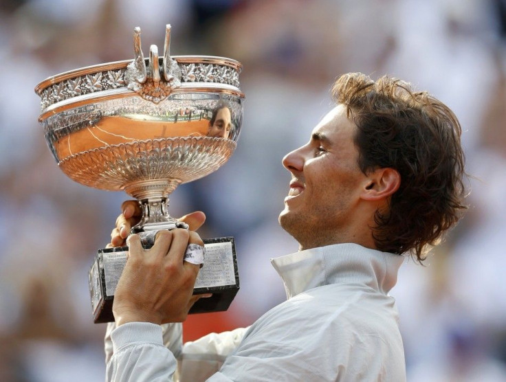 Rafael Nadal of Spain holds the trophy during the ceremony after defeating Novak Djokovic of Serbia during their men's singles final match to win the French Open Tennis tournament at the Roland Garros stadium in Paris June 8, 2014. 