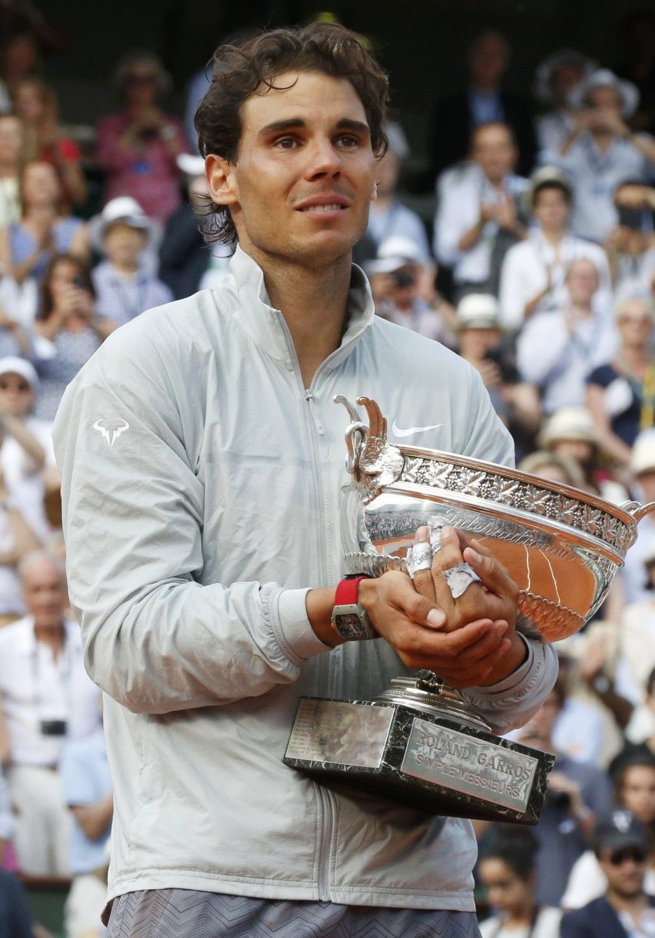 Rafael Nadal of Spain holds the trophy during the ceremony after defeating Novak Djokovic of Serbia during their mens singles final match to win the French Open Tennis tournament at the Roland Garros stadium in Paris June 8, 2014. 