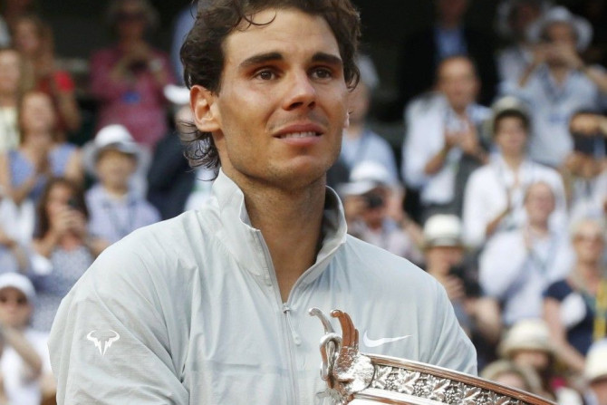 Rafael Nadal of Spain holds the trophy during the ceremony after defeating Novak Djokovic of Serbia during their men's singles final match to win the French Open Tennis tournament at the Roland Garros stadium in Paris June 8, 2014. 