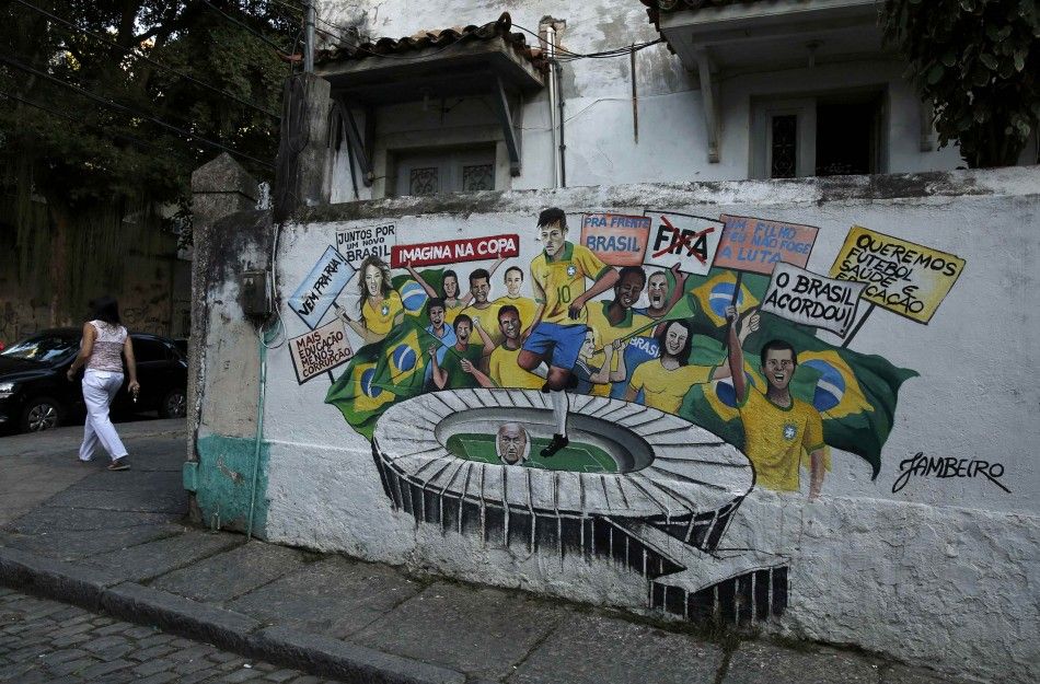 A woman passes a street mural of Brazils Neymar