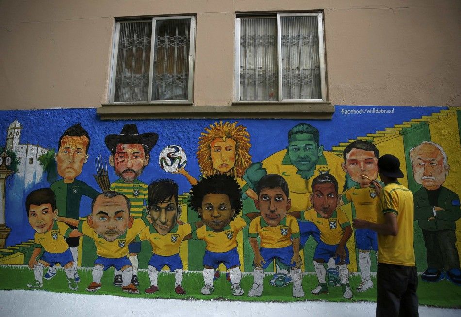 An artist paints a wall mural of the Brazilian national soccer team