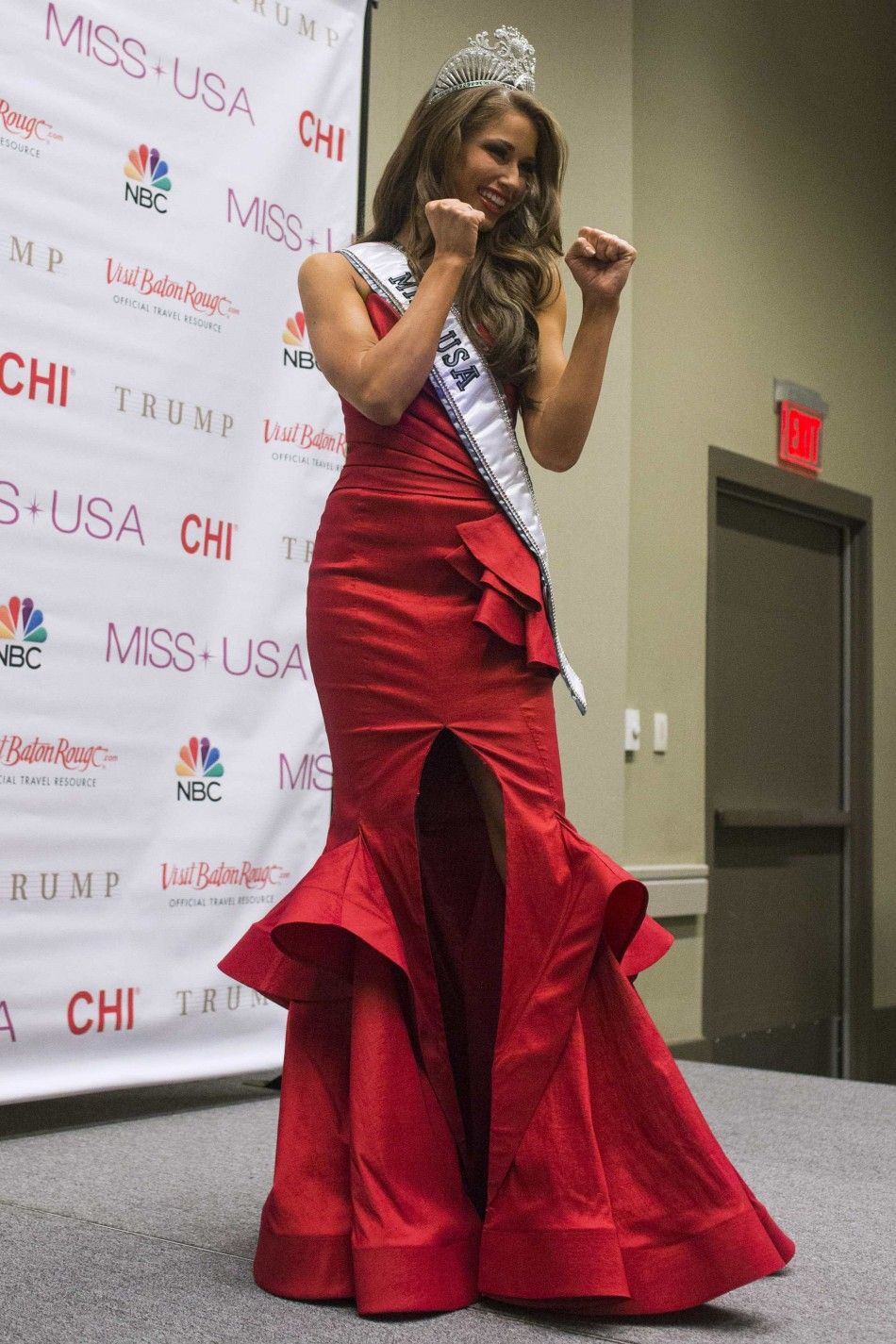 Miss Nevada Nia Sanchez poses in a taekwondo martial art stance for the media at a news conference after she won the 2014 Miss USA beauty pageant in Baton Rouge, Louisiana