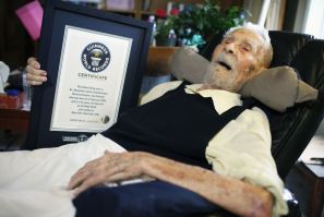 File photo of 111-year-old Alexander Imich holding Guinness World Records certificate recognizing him as world&#039;s oldest living man at home in New York City