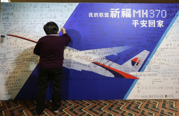 A mother writes message to son on board dedicated to passengers onboard missing Malaysia Airlines Flight MH370 in Beijing