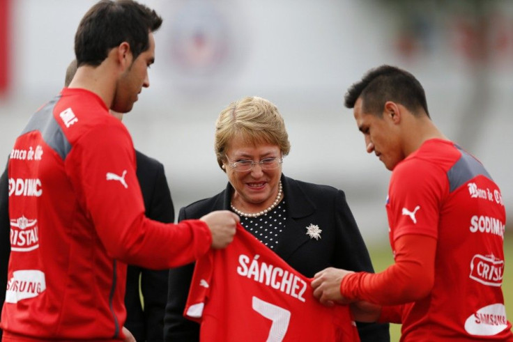 Chile's President Bachelet receives a national soccer team jersey from Chilean goalkeeper Bravo and Sanchez in Santiago