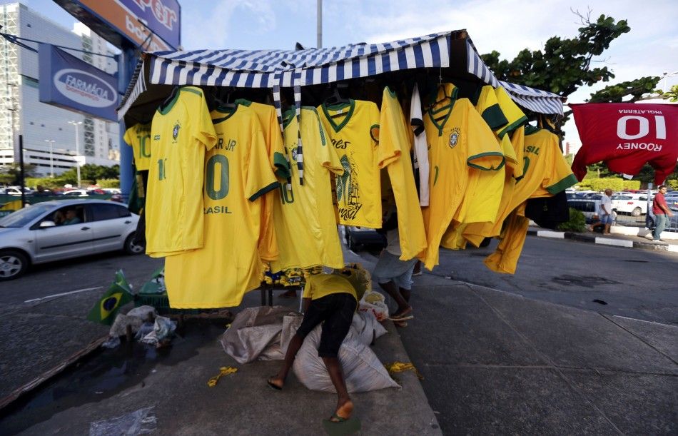 A boy manages a street store selling mainly  Brazil national soccer team jerseys 