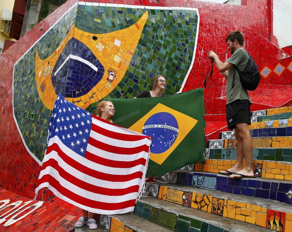 Tourists pose with a U.S. and Brazilian flag 