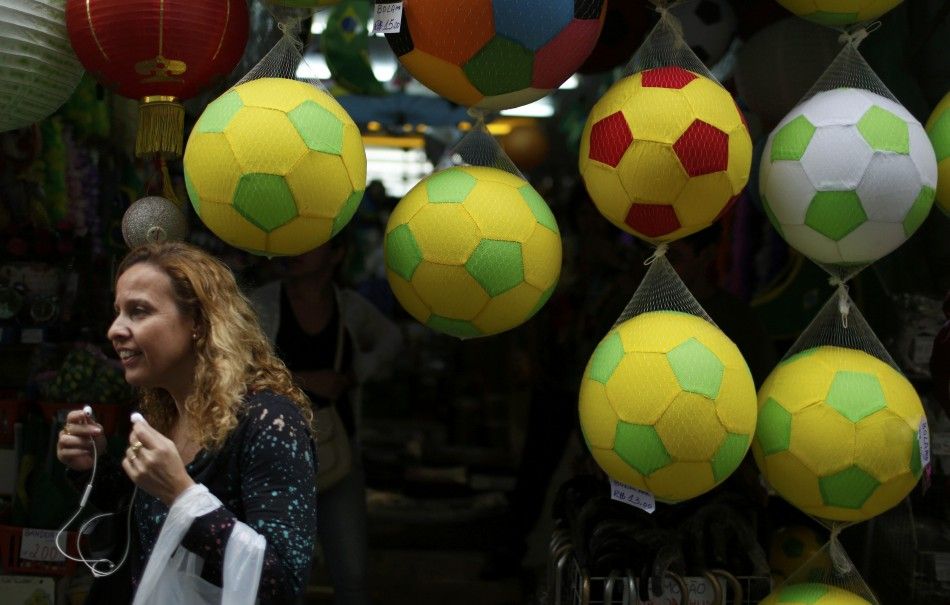 A woman walks past a shop selling World Cup souvenirs 
