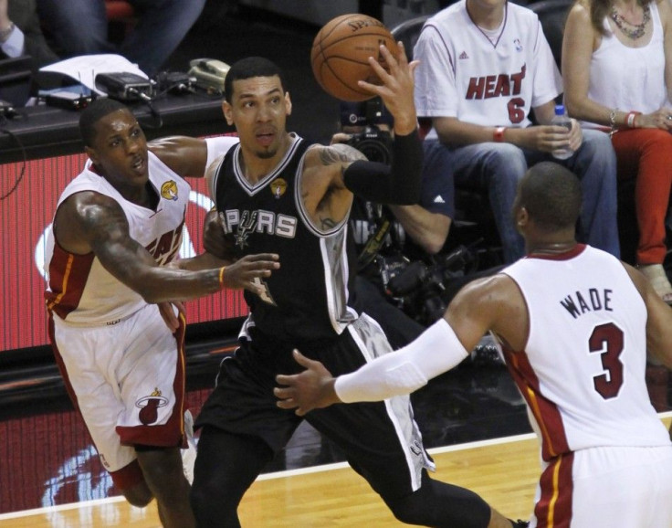 San Antonio Spurs' Danny Green (C) makes a steal from Miami Heat's Dwyane Wade (R) as Miami's Mario Chalmers defends during the first quarter in Game 3 of their NBA Finals basketball game in Miami, Florida, June 10, 2014. 