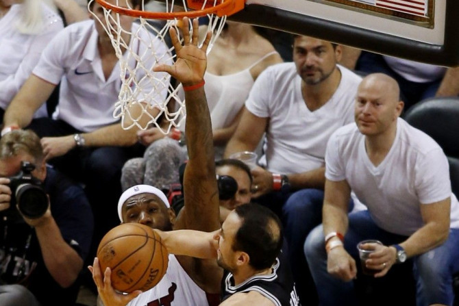 Jun 10, 2014; Miami, FL, USA; San Antonio Spurs guard Manu Ginobili (20) shoots around the defense of Miami Heat forward LeBron James (6) during the second quarter of game three of the 2014 NBA Finals at American Airlines Arena. 