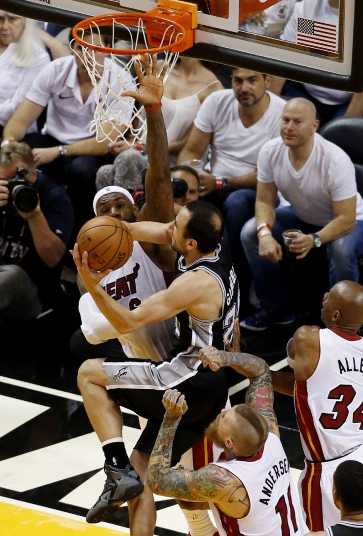 Jun 10, 2014; Miami, FL, USA; San Antonio Spurs guard Manu Ginobili (20) shoots around the defense of Miami Heat forward LeBron James (6) during the second quarter of game three of the 2014 NBA Finals at American Airlines Arena.