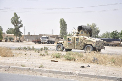 Iraqi security forces leave a military base as Kurdish forces take over control in Kirkuk June 11, 2014.