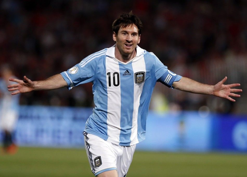 Argentinas Lionel Messi celebrates after he scored his teams first goal against Chile during the 2014 World Cup qualifying soccer match in Santiago, in this October 16, 2012 file photo. With the soccer World Cup only three months away, Adidas and Nike a