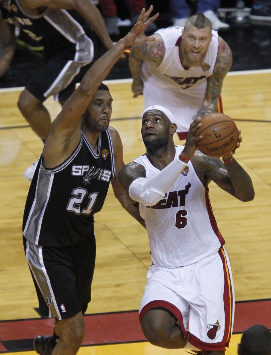 San Antonio Spurs Tim Duncan L defends against Miami Heats LeBron James as Miamis Chris Andersen looks on during the fourth quarter in Game 3 of their NBA Finals basketball series in Miami, Florida, June 10, 2014. REUTERSAndrew Innerarity 