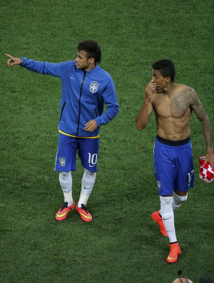 Brazil's Neymar (L) gestures next to teammate Luiz Gustavo after the 2014 World Cup opening match against Croatia at the Corinthians arena in Sao Paulo June 12, 2014. 