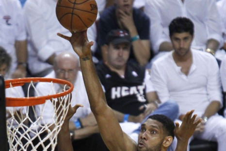San Antonio Spurs' Tim Duncan (R) puts up a shot past Miami Heat's Chris Bosh during the second quarter in Game 4 of their NBA Finals basketball series in Miami, Florida, June 12, 2014.