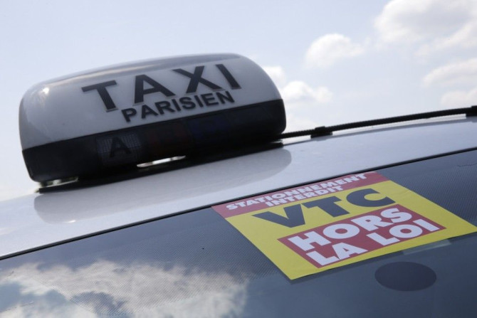 A yellow ribbon indicates a striking Paris taxi which takes part in a demonstration in the French capital June 11, 2014.