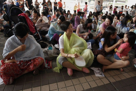 Dozens of mothers take part in a breastfeeding flash mob demonstration at a public place in Hong Kong June 14, 2014.