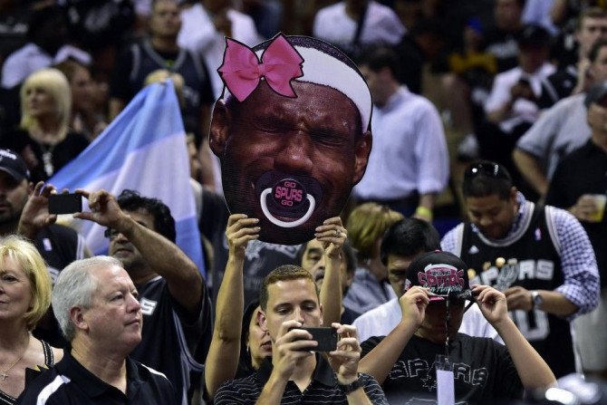 Jun 15, 2014; San Antonio, TX, USA; A San Antonio Spurs fan holds up a sign of Miami Heat forward LeBron James (not pictured) before game five of the 2014 NBA Finals at AT&T Center. 