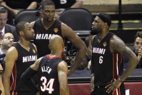 Miami Heat players (L-R) Dwyane Wade, Chris Bosh, Ray Allen, and LeBron James wait during a timeout against the San Antonio Spurs during the first half in Game 5 of their NBA Finals basketball series in San Antonio, Texas, June 15, 2014. 