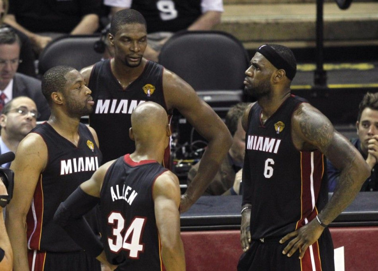 Miami Heat players (L-R) Dwyane Wade, Chris Bosh, Ray Allen, and LeBron James wait during a timeout against the San Antonio Spurs during the first half in Game 5 of their NBA Finals basketball series in San Antonio, Texas, June 15, 2014. 