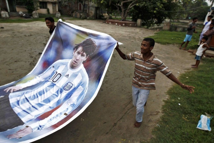 Fans of Argentina&#039;s soccer team carry a giant picture of Argentina&#039;s player Lionel Messi as they celebrate their team&#039;s win over Bosnia in the 2014 FIFA World Cup, in Kolkata