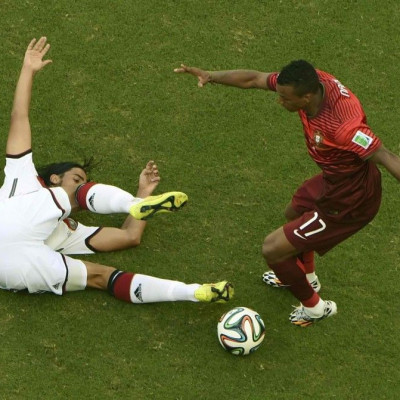 Germany's Sami Khedira fights for the ball with Portugal's Nani during their 2014 World Cup Group G soccer match at the Fonte Nova arena in Salvador June 16, 2014. 