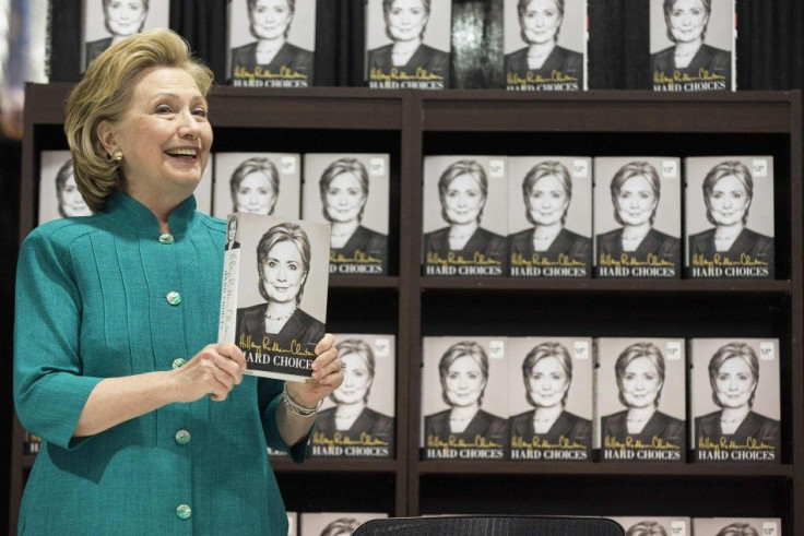Former U.S. Secretary of State Hillary Clinton smiles as she arrives to sign copies of her book &quot;Hard Choices&quot; at a Costco store in Arlington, Virginia