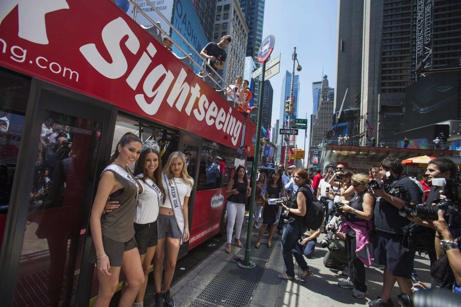 Miss Universe Gabriela Isler L-R, Miss USA 2014 Nia Sanchez and Miss Teen USA Cassidy Wolf pose in front of a Gray Line double decker sightseeing bus ahead of their tour of New York City June 16, 2014.     REUTERSAdrees Latif  