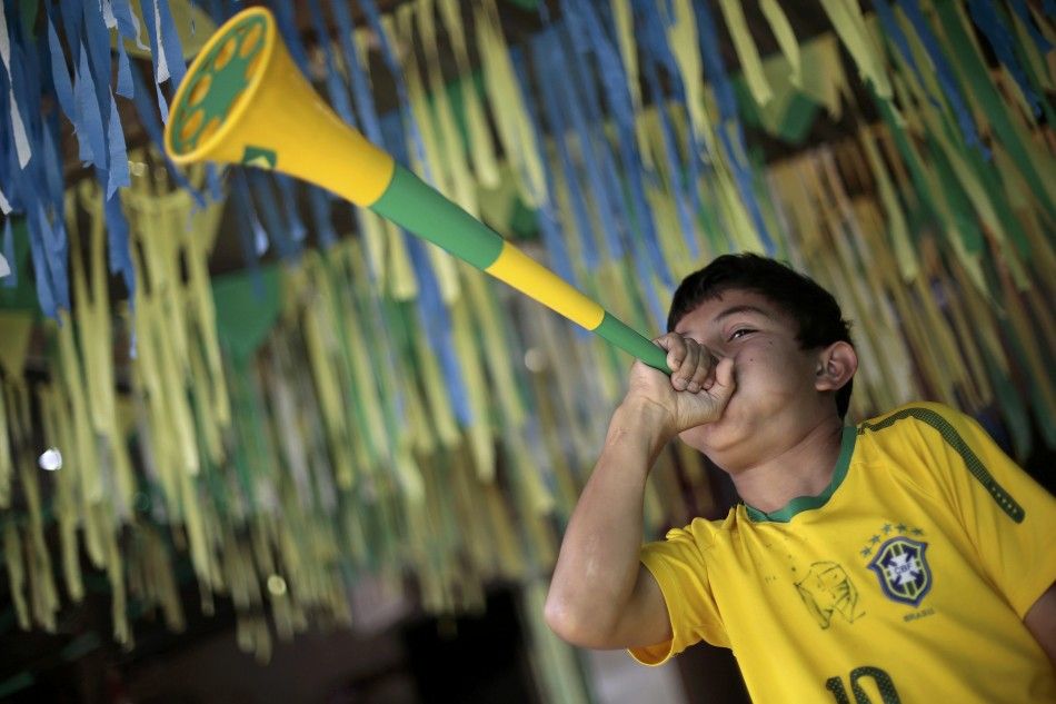 A Brazil soccer fan blows a horn