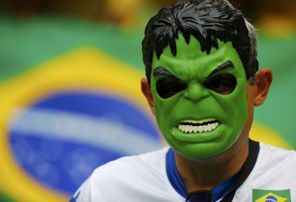 A fan of Brazil wearing a mask of comic character the Hulk
