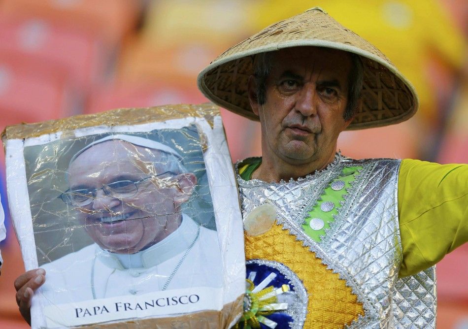 A fan poses with a picture of Pope Francis