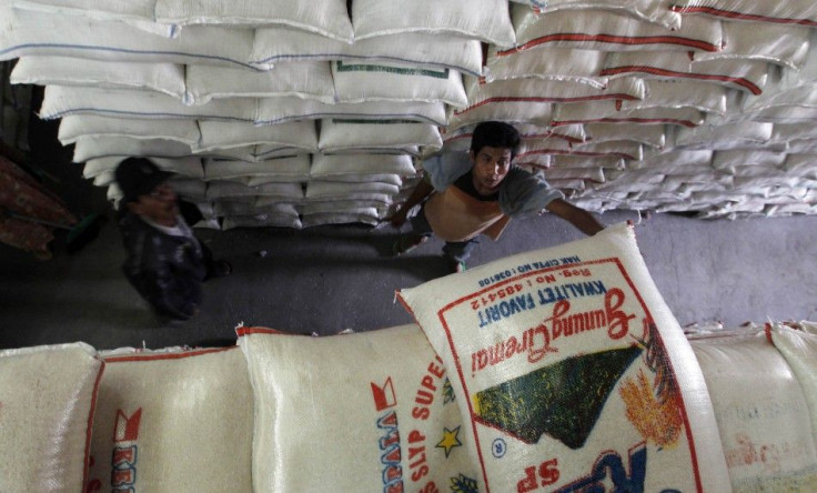 A worker unloads a sack of rice at the central rice market in Jakarta