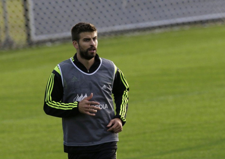 Spain's player Gerard Pique runs during a training session ahead of the 2014 World Cup in Curitiba