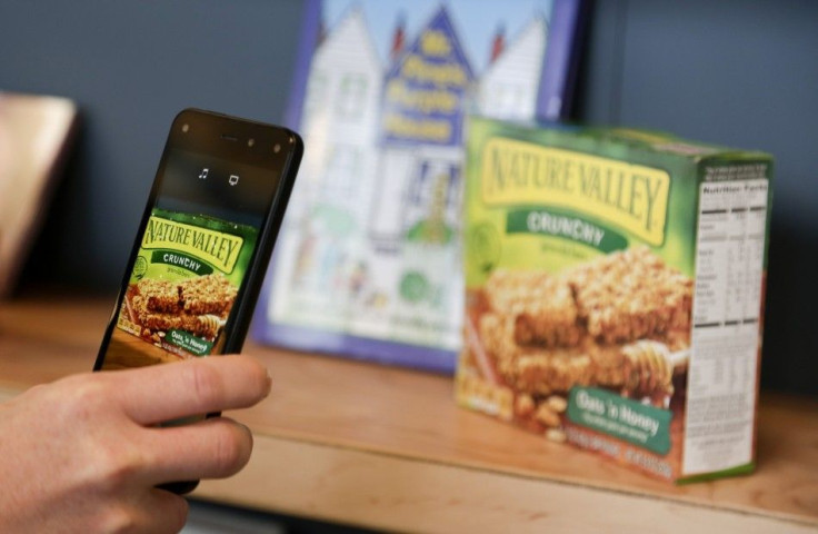 An Amazon representative shows off the Firefly scanning feature on the company's new Fire smartphone at the company's campus in Seattle, Washington June 18, 2014. Amazon.com Inc's new cellphone seeks to offer shoppers instant gratification