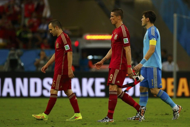 Spain&#039;s Iniesta, Torres and Casillas walk off the pitch at the end of their 2014 World Cup Group B soccer match in Rio de Janeiro