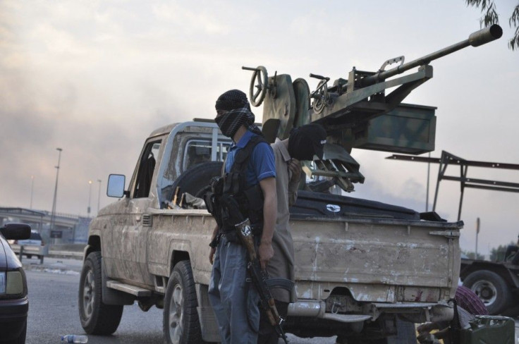 Fighters of the Islamic State stand guard at a checkpoint in the Northern Iraq City of Mosul