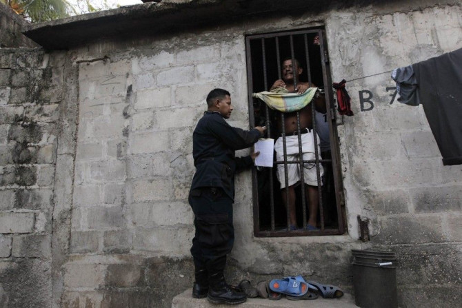 A policeman locks up the cell of inmates at the jail where crew members of Florida-based shipwreck salvage company Aqua Quest International have been detained, in Puerto Lempira, on the Mosquito coast of northeastern Honduras June 8, 2014. The crew of the