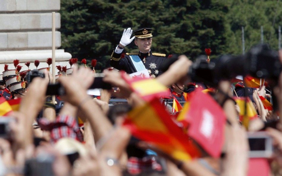 Spains new King Felipe VI waves to the crowd
