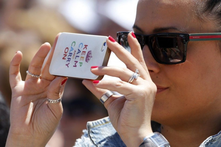 A Woman Takes Photos With Her iPhone.