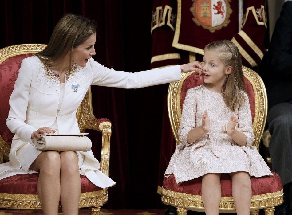 Spains Queen Letizia L touches the cheek of her daughter Princess Leonor 