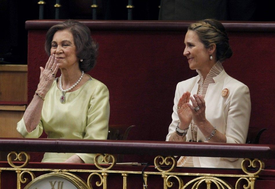 Spains Queen Sofia L blows a kiss as Infanta Elena applauds 