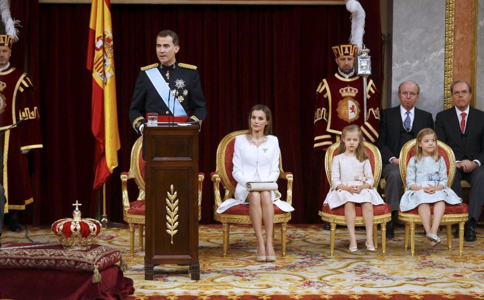 Spains new King Felipe VI L delivers a speech next to his wife Queen Letizia 2ndL, their daughters Princess Leonor and Princess Sofia 