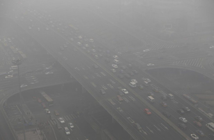 Vehicles drive through the Guomao Bridge on a heavy haze day in Beijing's central business district January 29, 2013. China plans to take more than 5 million ageing vehicles off its roads this year in a bid to improve air quality, with 330,000 cars s