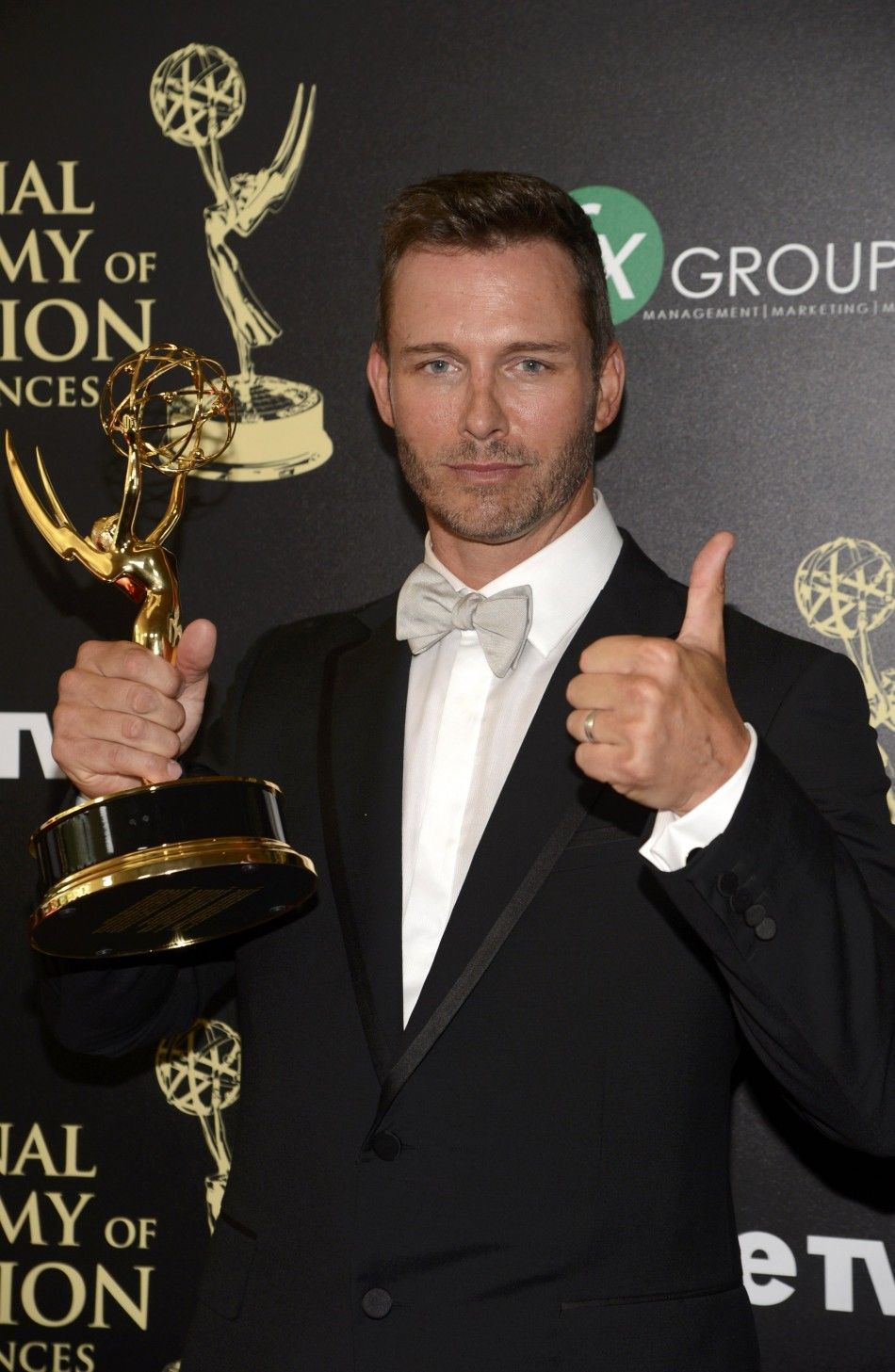 Eric Martsolf Poses Backstage with the Award for Outstanding Supporting Actor in a Drama Series for His Role in Days of Our Lives During the 41st Annual Daytime Emmy Awards in Beverly Hills