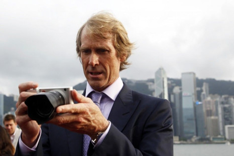 U.S. director Michael Bay takes pictures with his camera on the red carpet as he arrives for the world premiere of the film &quot;Transformers: Age of Extinction&quot; in Hong Kong June 19, 2014.