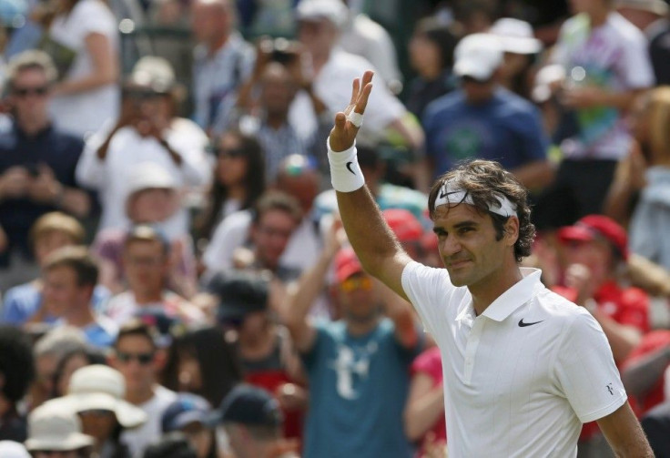 Roger Federer of Switzerland waves after defeating Paolo Lorenzi of Italy in their men&#039;s singles tennis match at the Wimbledon Tennis Championships, in London June 24, 2014.            REUTERS/Stefan Wermuth