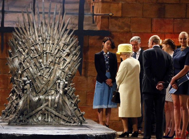 Britain&#039;s Queen Elizabeth looks at the Iron Throne as she meets members of the cast on the set of the television series Game of Thrones in the Titanic Quarter of Belfast, Northern Ireland, June 24, 2014.