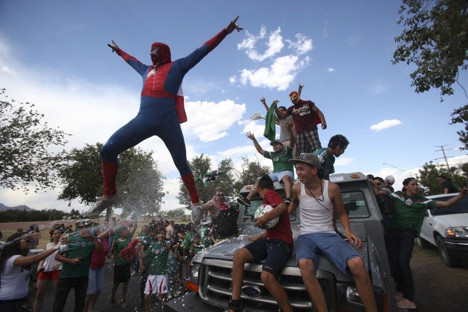 A Mexican Soccer Fan, Dressed in a Spiderman Costume, Jumps from a Vehicle as He Celebrates Mexicos World Cup Soccer Match Win Over Croatia