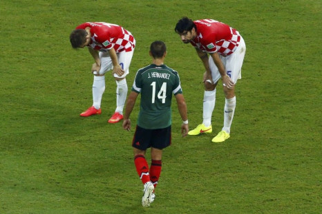 Croatia's Modric and Corluka React Near Mexico's Hernandez After Their 2014 World Cup Group A Soccer Match in Recife